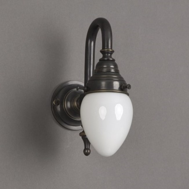 Bathroom wall lamp with bronze armature and small, ellips shaped, opal white glass shade